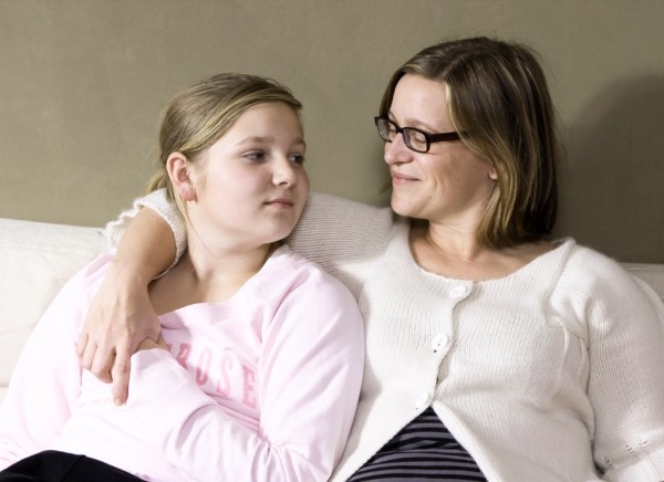 Mother and daughter close on couch