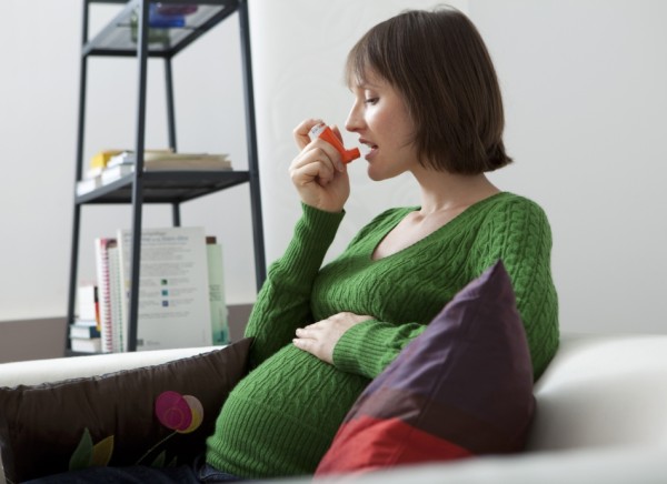Pregnant woman using inhaler