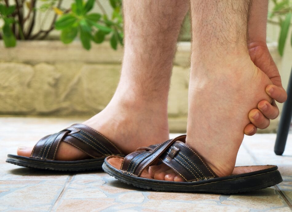 Woman with sore heel while wearing sandals