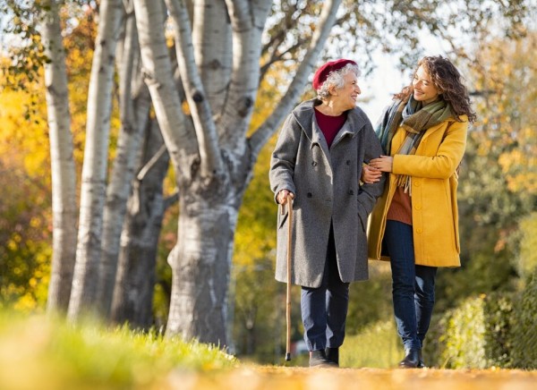 Older woman walking to stay fit with friend 