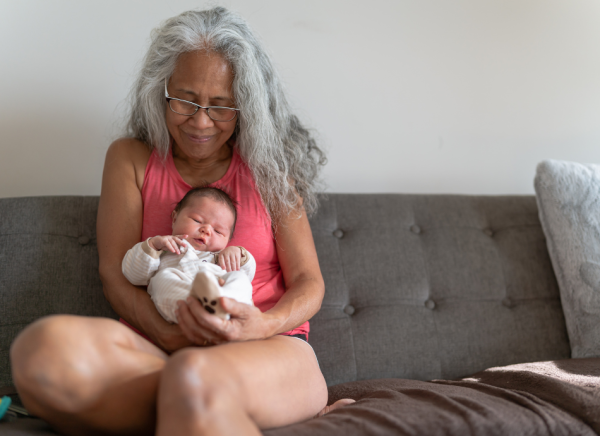 Grandmother holding grandchild on couch
